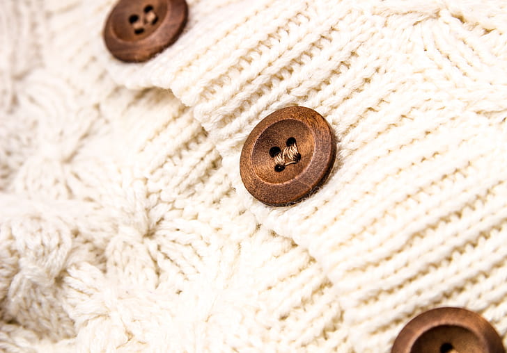 white knit apparel with brown buttons