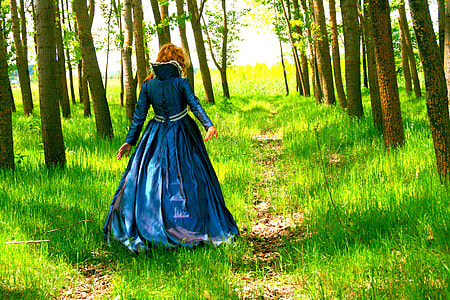 woman walking on green grass during daytime