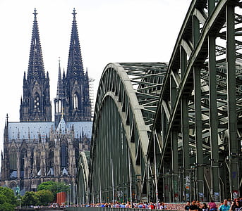 People Walling on Cologne Bridge Near Cologne Cathedral during Daytime