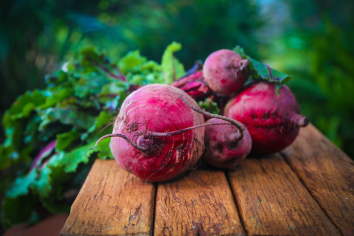 red beet on brown wooden surface