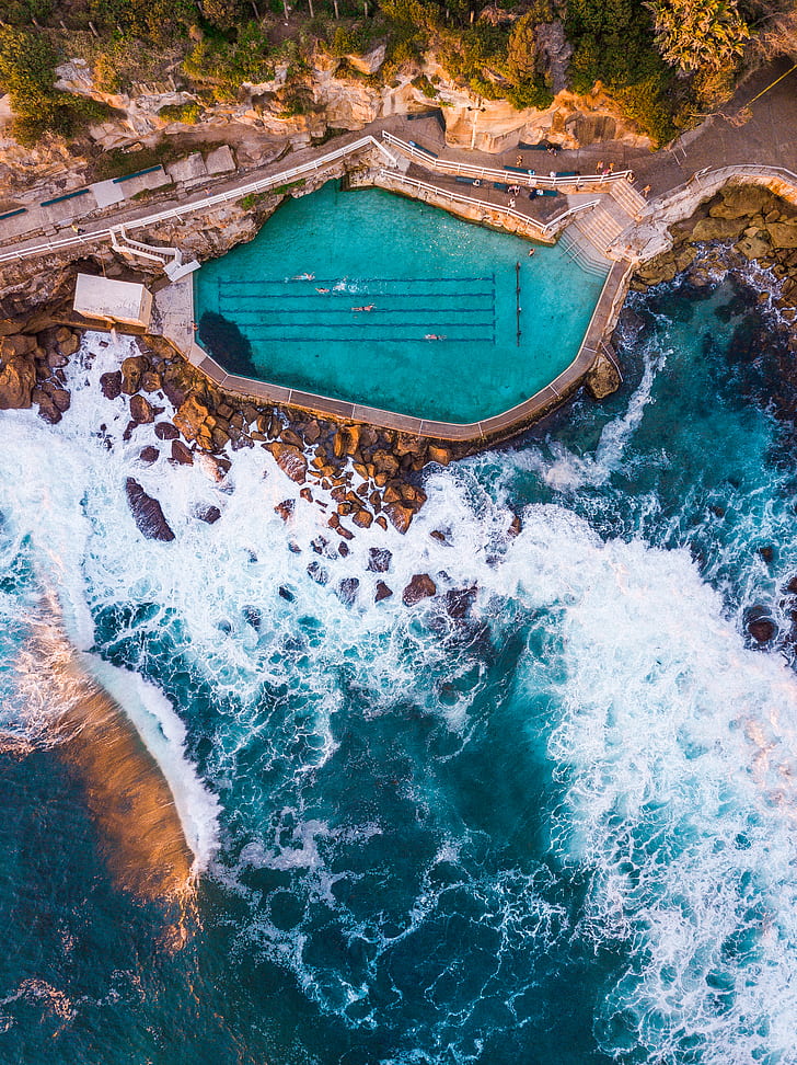 aerial photography of pool beside cliff