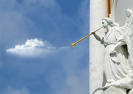angel blowing wind instrument statue