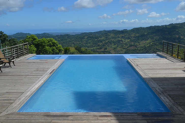 blue and gray pool over looking the mountain ranges