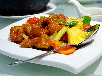 sweet and sour chicken with vegetables on white ceramic plate