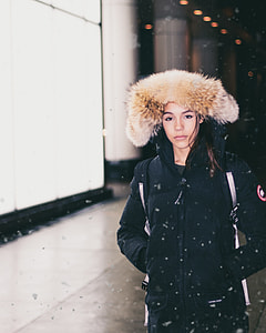 woman in black and brown parka coat during winter