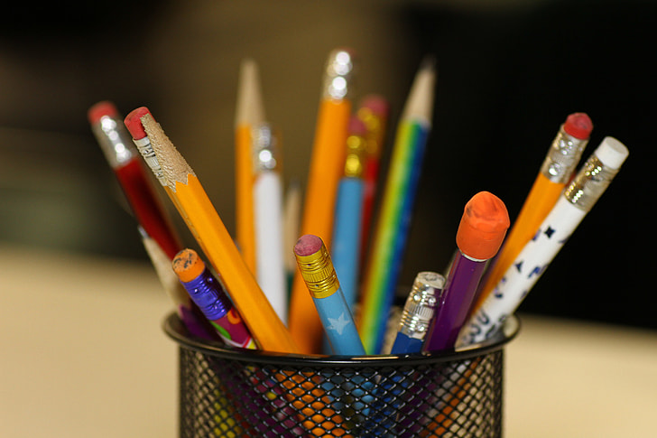 assorted-color pencil on pen organizer