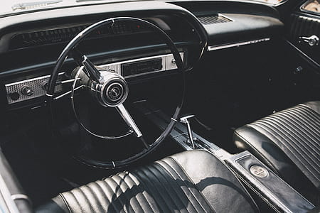black steering wheel and black leather bucket seat