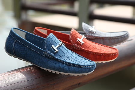 three unpaired men's boat shoes