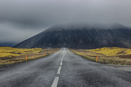 A road with mountains in the background in Iceland