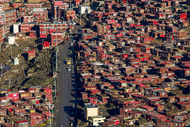 aerial view of red painted building and houses with main concrete road
