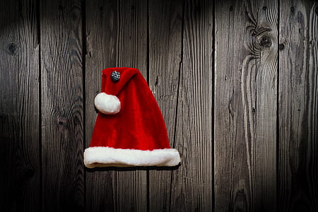 red santa hat on top of gray wood