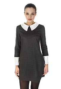 woman wearing black and white pan collared long-sleeved dress