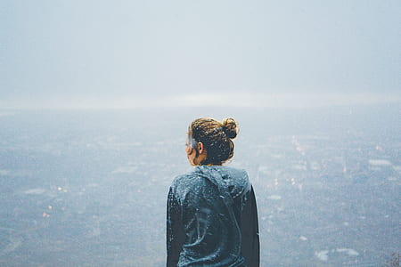 woman wearing gray hoodie jacket overlooking the city