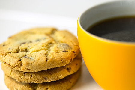 Closeup shot of yellow coffee cup and cookie biscuits. Image captured with a Canon 6D DSLR