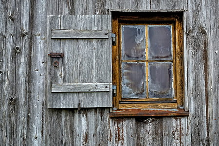 photo of clear glass window with brown wooden frame