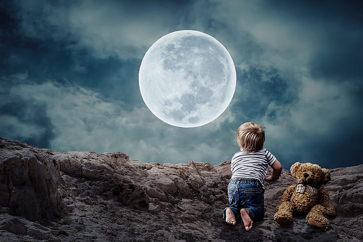 boy beside bear plush looking at moon