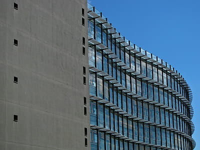 Grey Concrete Building With Blue Windows