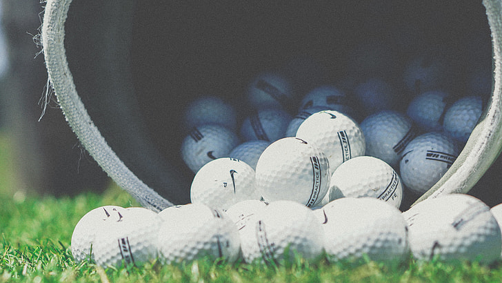 selective focus photograph of golf balls