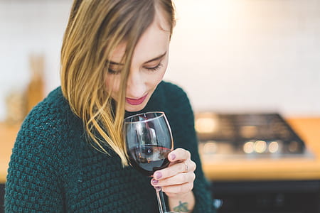 photo of woman holding wine glass