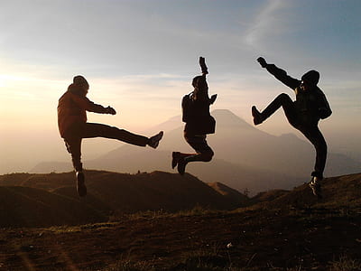 group of three people doing jump shot