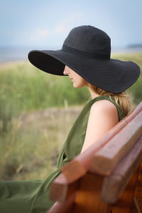 selective focus photography of woman wearing black sun hat