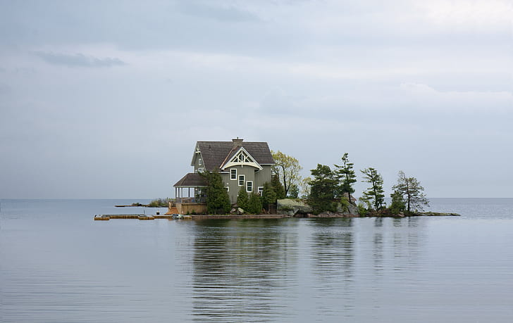 white and brown wooden house in front of lake photography
