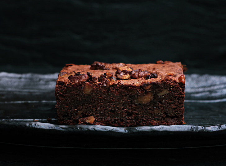 selective photography of chocolate cake with peanuts