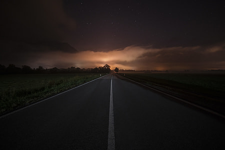 photo of gray concrete road during night time