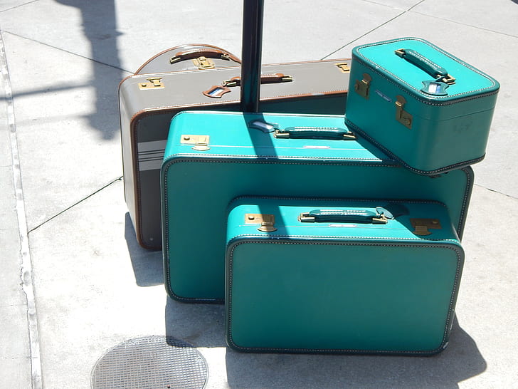 three teal and two gray suit case set