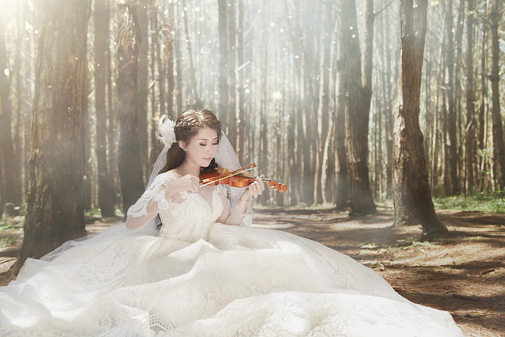 woman in white wedding dress playing violin