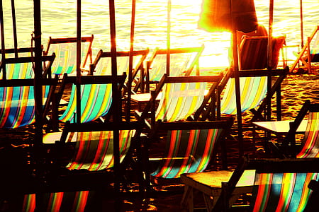 assorted-color lounge chair near sea at daytime