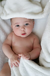baby under white textile