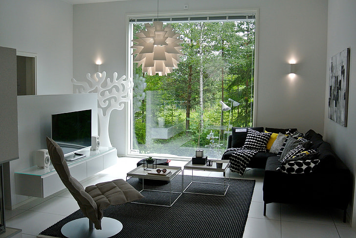 black fabric sectional sofa beside the clear glass window