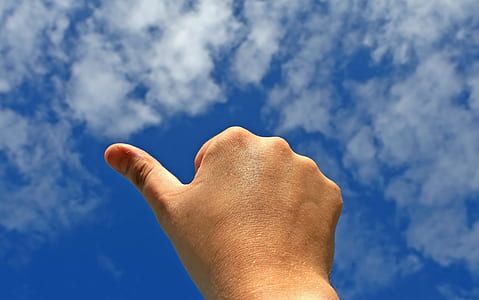 right human hand under blue sky