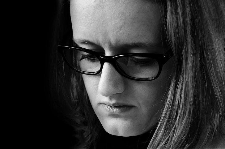 grayscale photo of woman's profile in eyeglasses