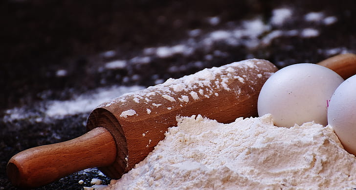 rolling pin with two eggs and flour