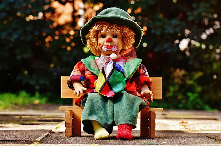 clown doll sitting on bench