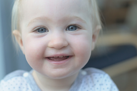 shallow focus photography of a toddler wearing white top