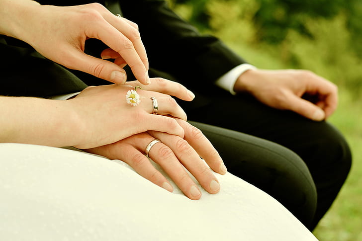bride and groom sitting on chair holding hands