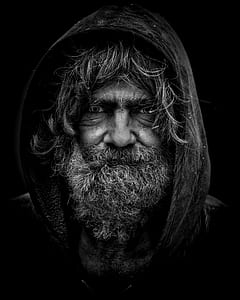 grayscale macro photograph of man in hoodie