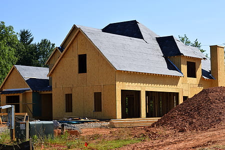 brown house beside soil under clear skies