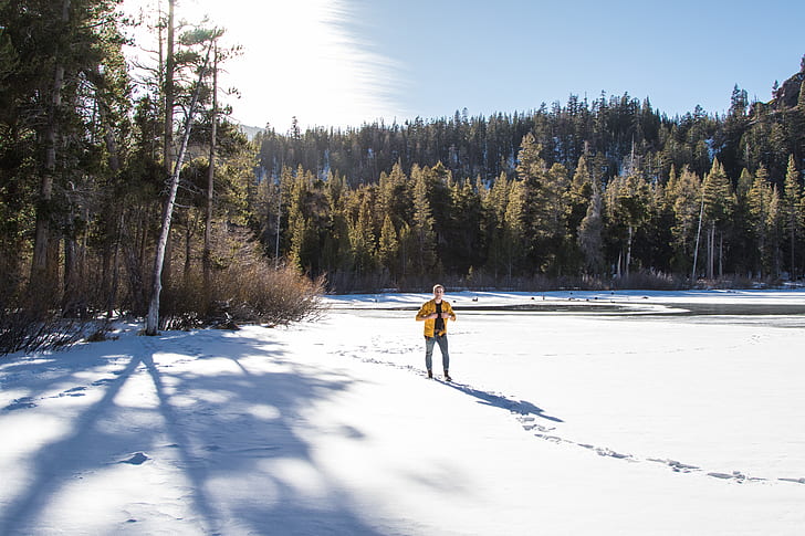 man standing on snow field during daytime