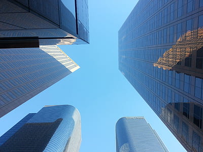 bottom view of buildings under blue sky