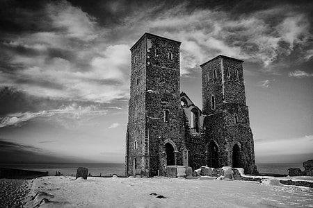 An old Saxon pair of towers sit on top of the cliffs at Reculver, Kent, England