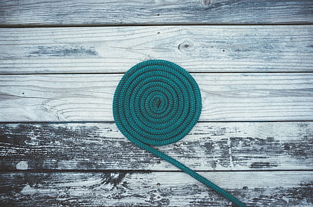 green rope on gray and white wooden panel