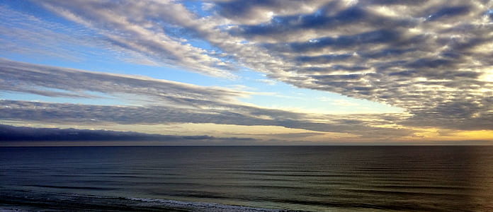 White Sky Under Blue Sea during Dawn