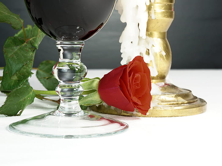 red rose near the wine glass