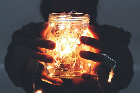 Man holding lights in a jar