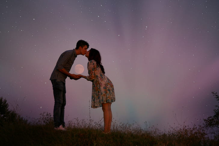 couple kissing with moon and stars in the background