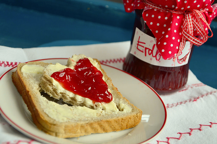 cream bread with strawberry jam on plate